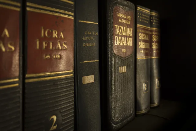 Detailed close-up of law and regulation books on a bookshelf, emphasizing education and knowledge. Referencer fra bureaukunder: sådan indhenter du dem lovligt